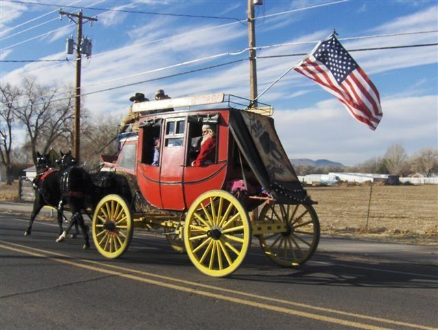 A horse drawn carriage with an american flag attached to it
