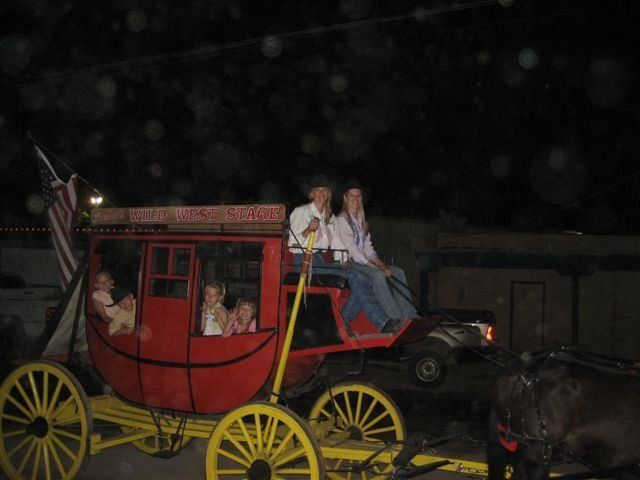 A horse drawn carriage with a sign that says ' cowboy ' on it