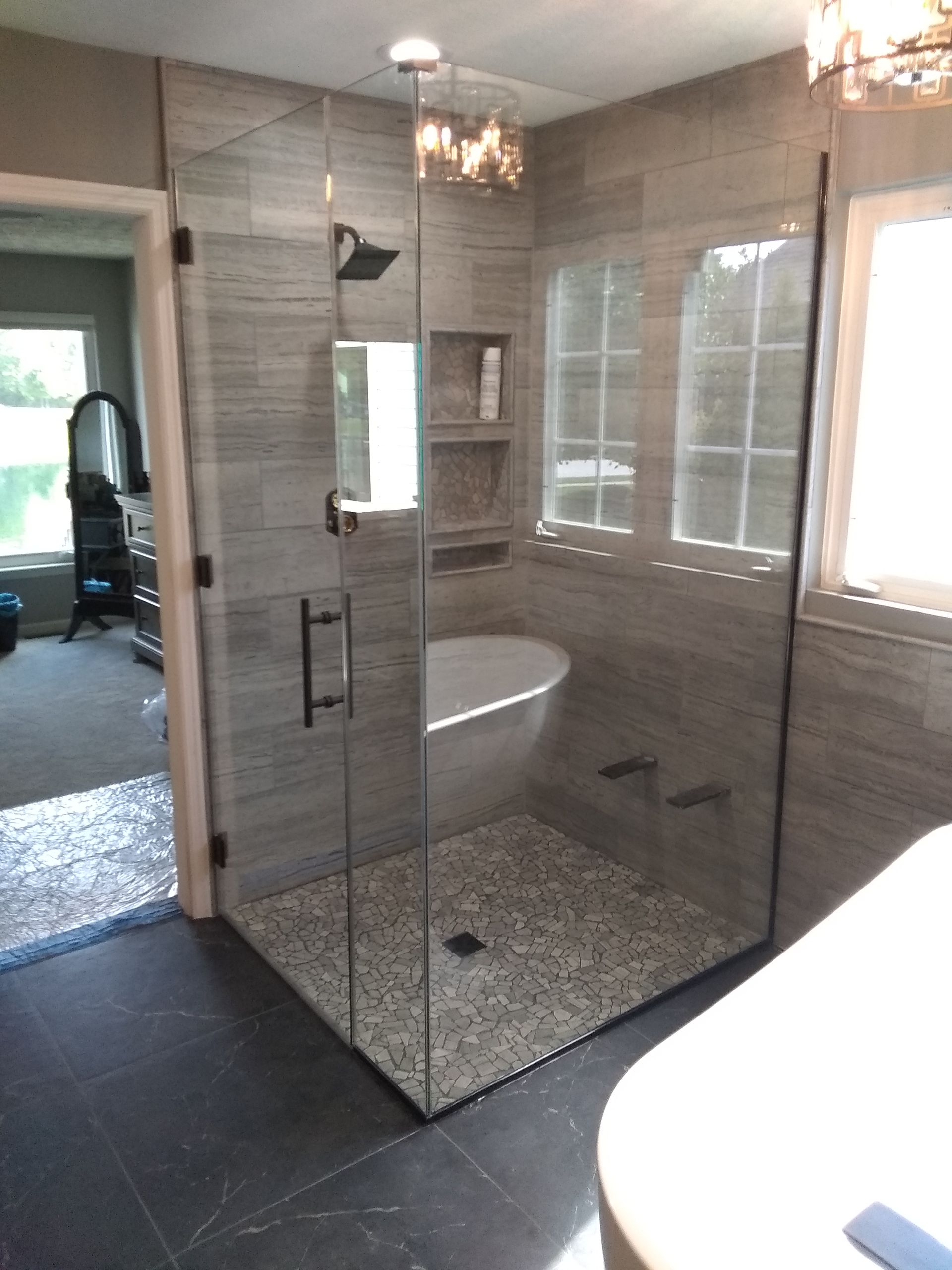 A shower stall with a glass door and a shower head.