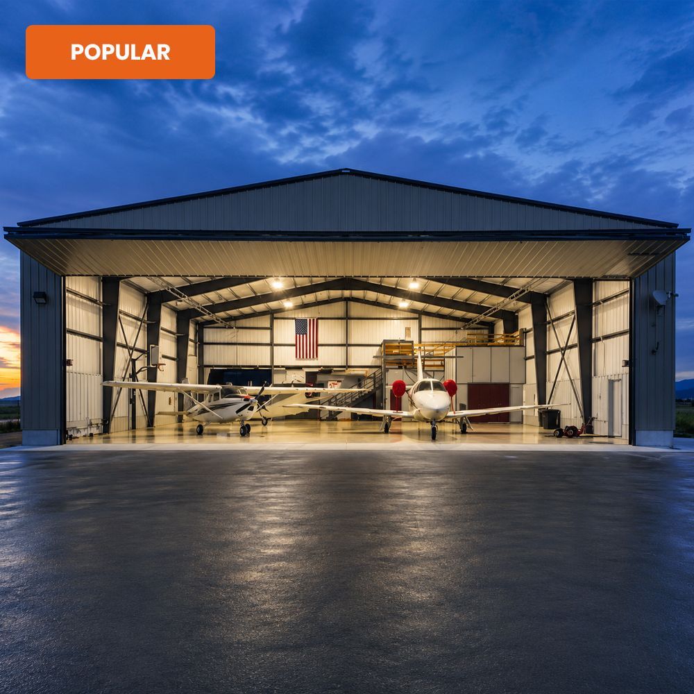 Open hangar at dusk with a small aircraft inside and a polished concrete floor