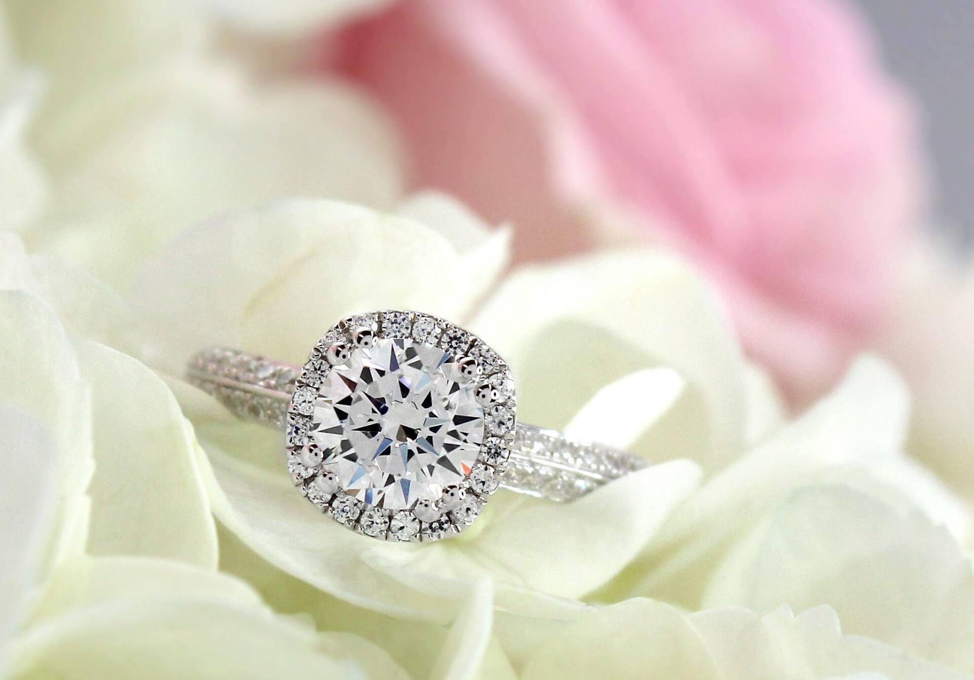 Diamond engagement ring on white and pink flowers