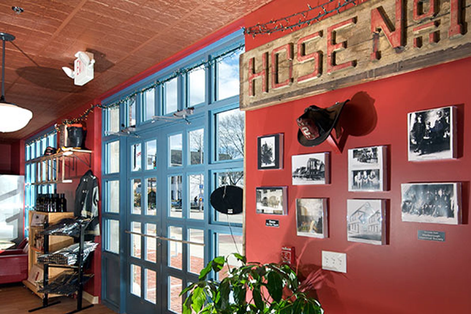 A red wall with a blue door and a sign that says