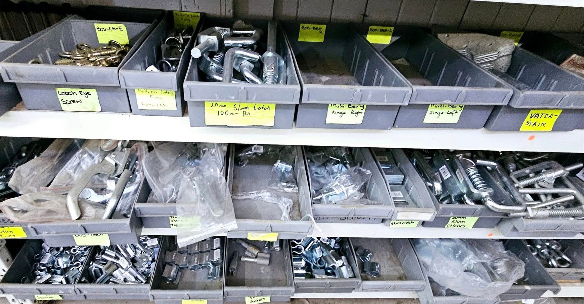 A shelf filled with lots of different types of nuts and bolts
