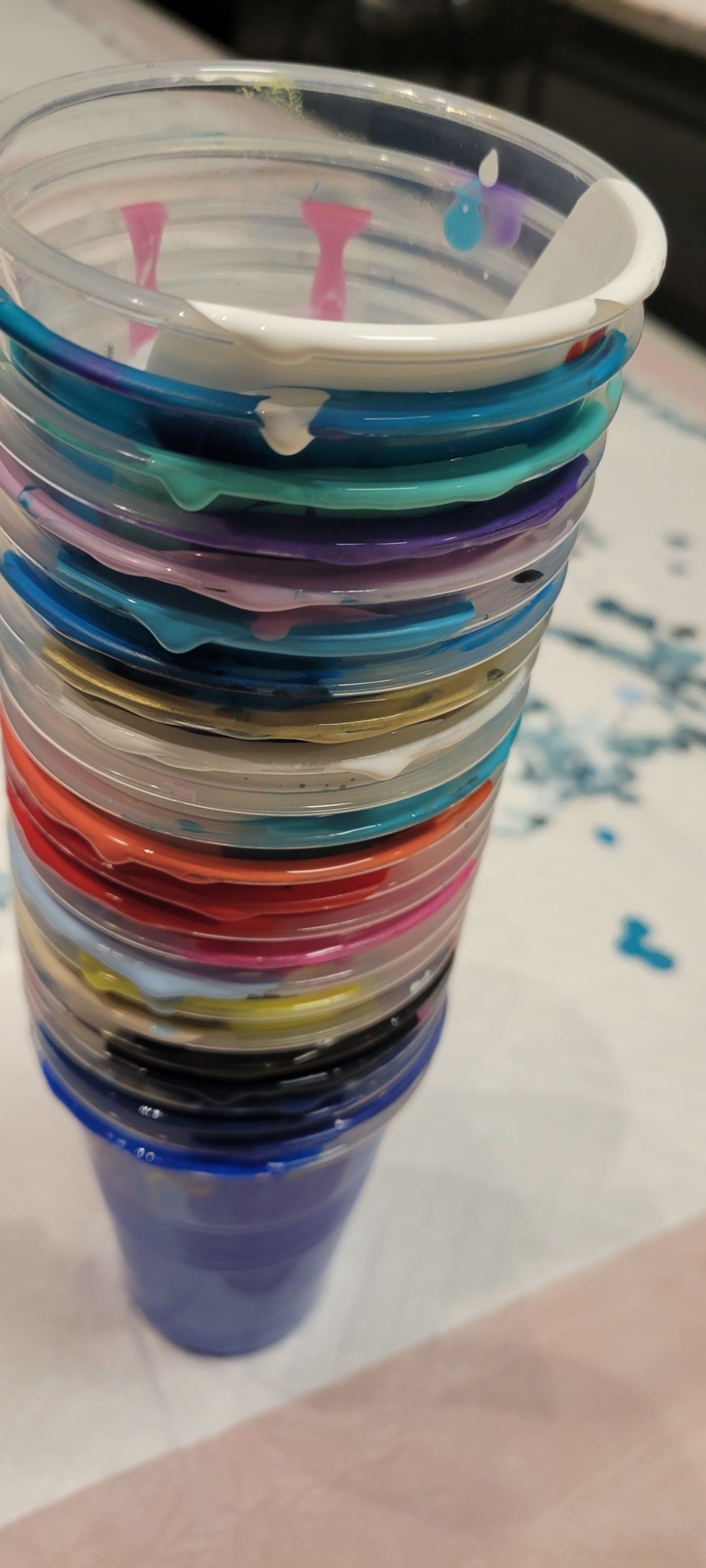Stack of colorful plastic cups nested together on a table