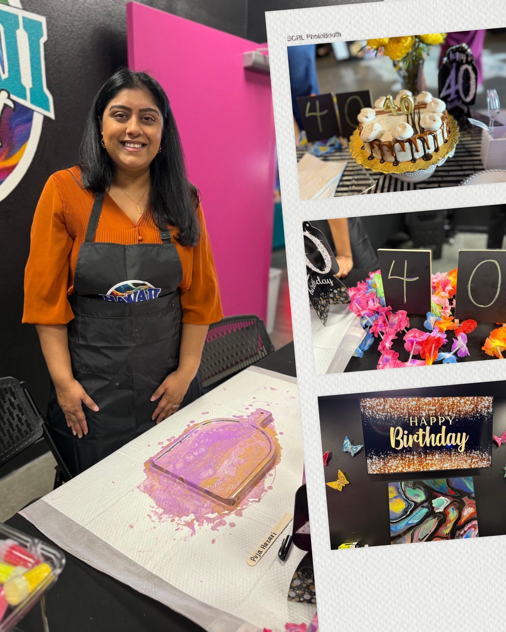 Woman in an apron standing beside a decorated cake display booth with colorful treats and a pink backdrop.