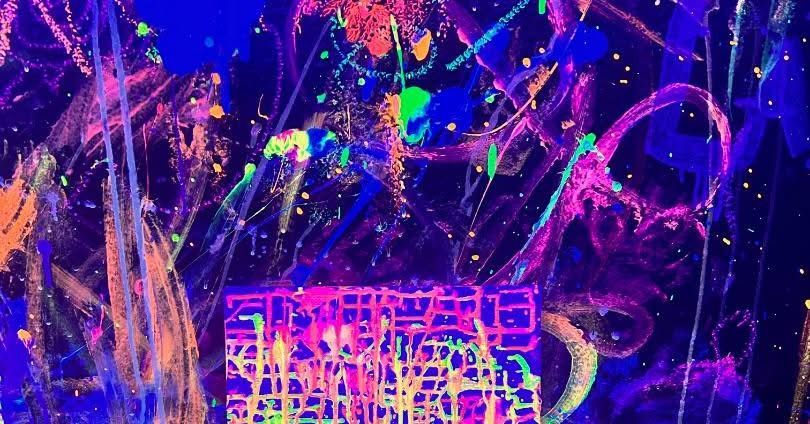 Abstract neon paint splashes in purple, pink, blue, and green on a dark background with a bright grid-like shape below