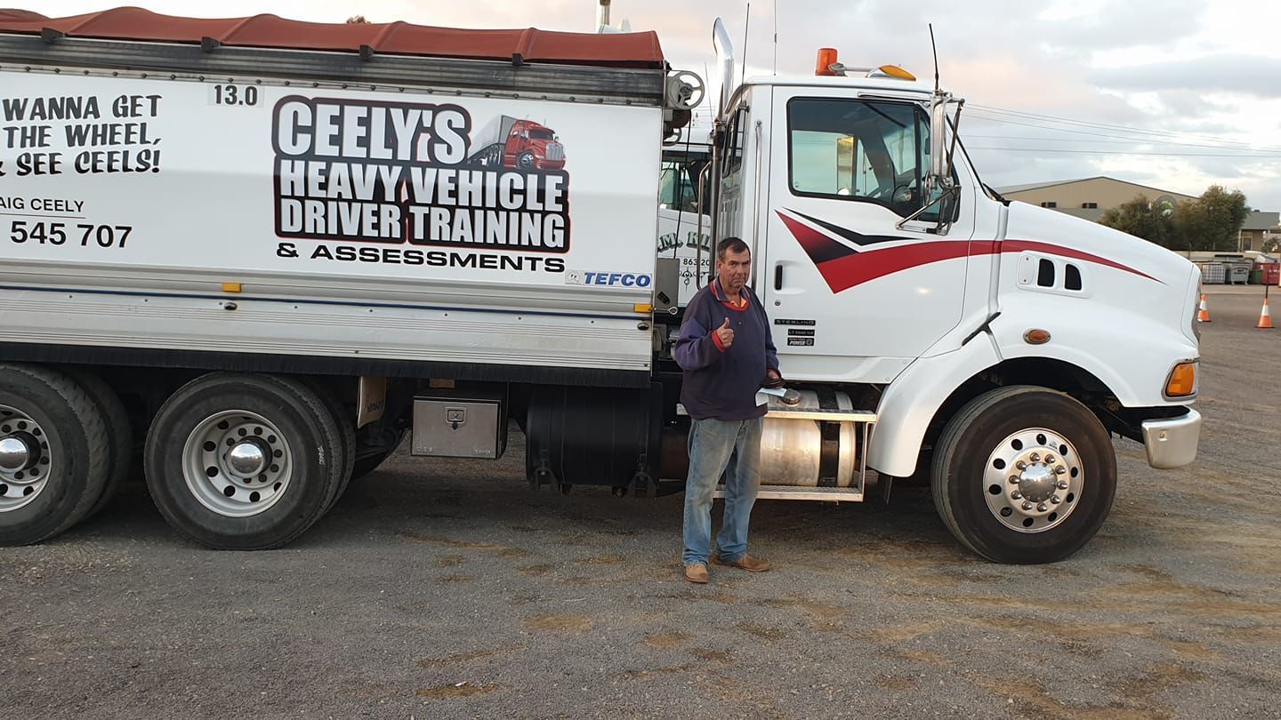 A Man is Standing in Vehicle Driver Training Truck — Ceely's Heavy Vehicle Driver Training & Assessments In Wagga Wagga, NSW 