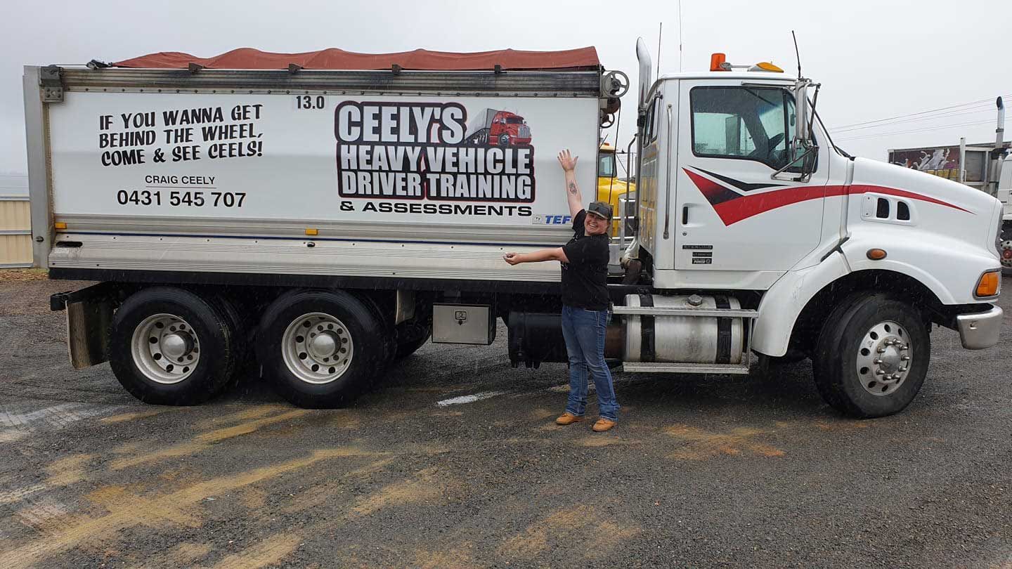 Woman Proud Showcasing Her Truck — Ceely's Heavy Vehicle Driver Training & Assessments In Wagga Wagga, NSW 
