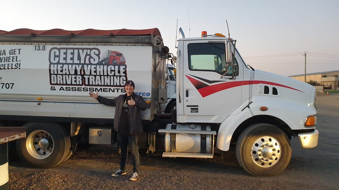 Student Truck Driver Posing Beside a Learner Vehicle — Ceely's Heavy Vehicle Driver Training & Assessments In Albury, NSW 