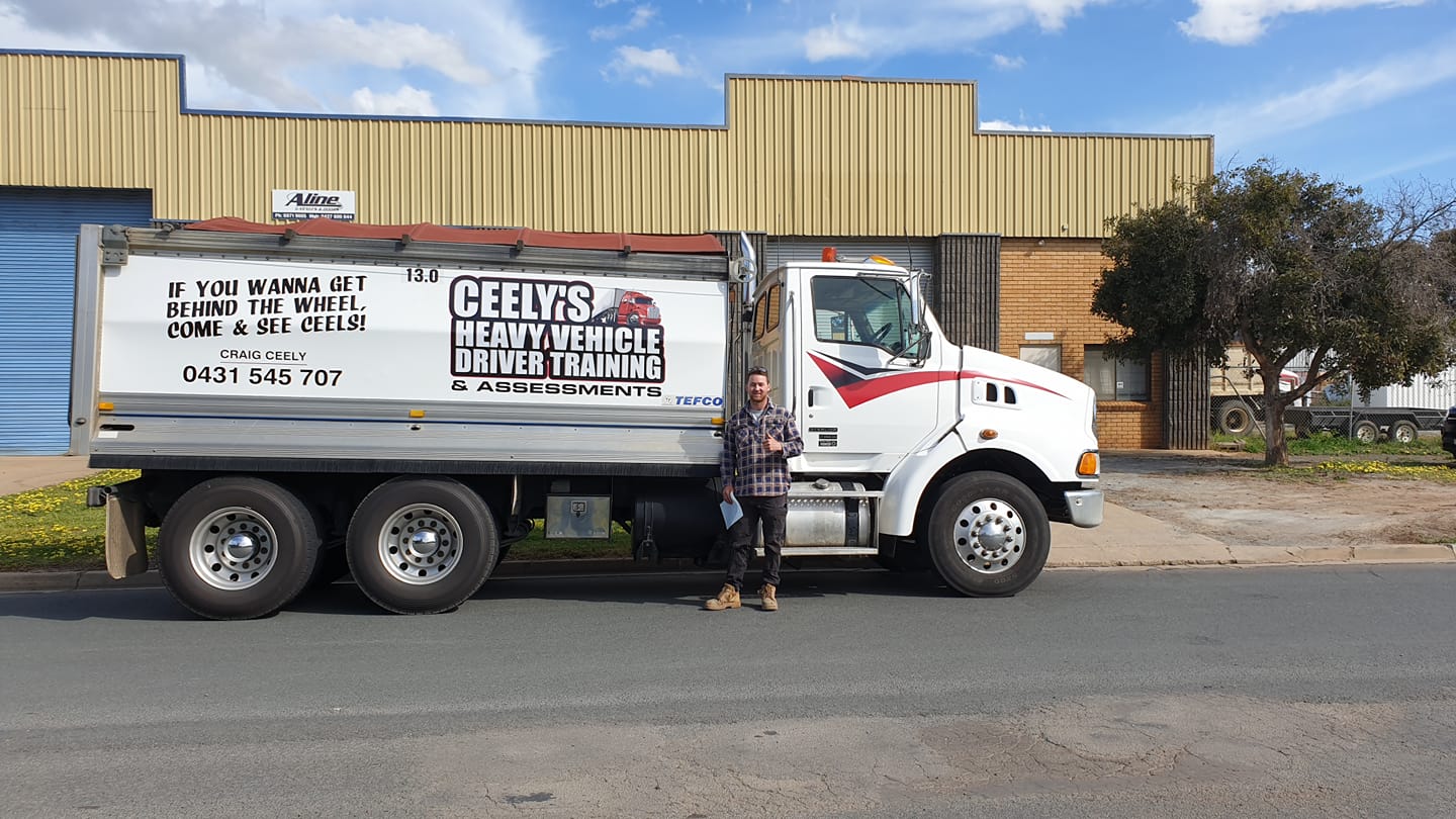 Driver On Red Truck — Ceely's Heavy Vehicle Driver Training & Assessments In Wagga Wagga, NSW 