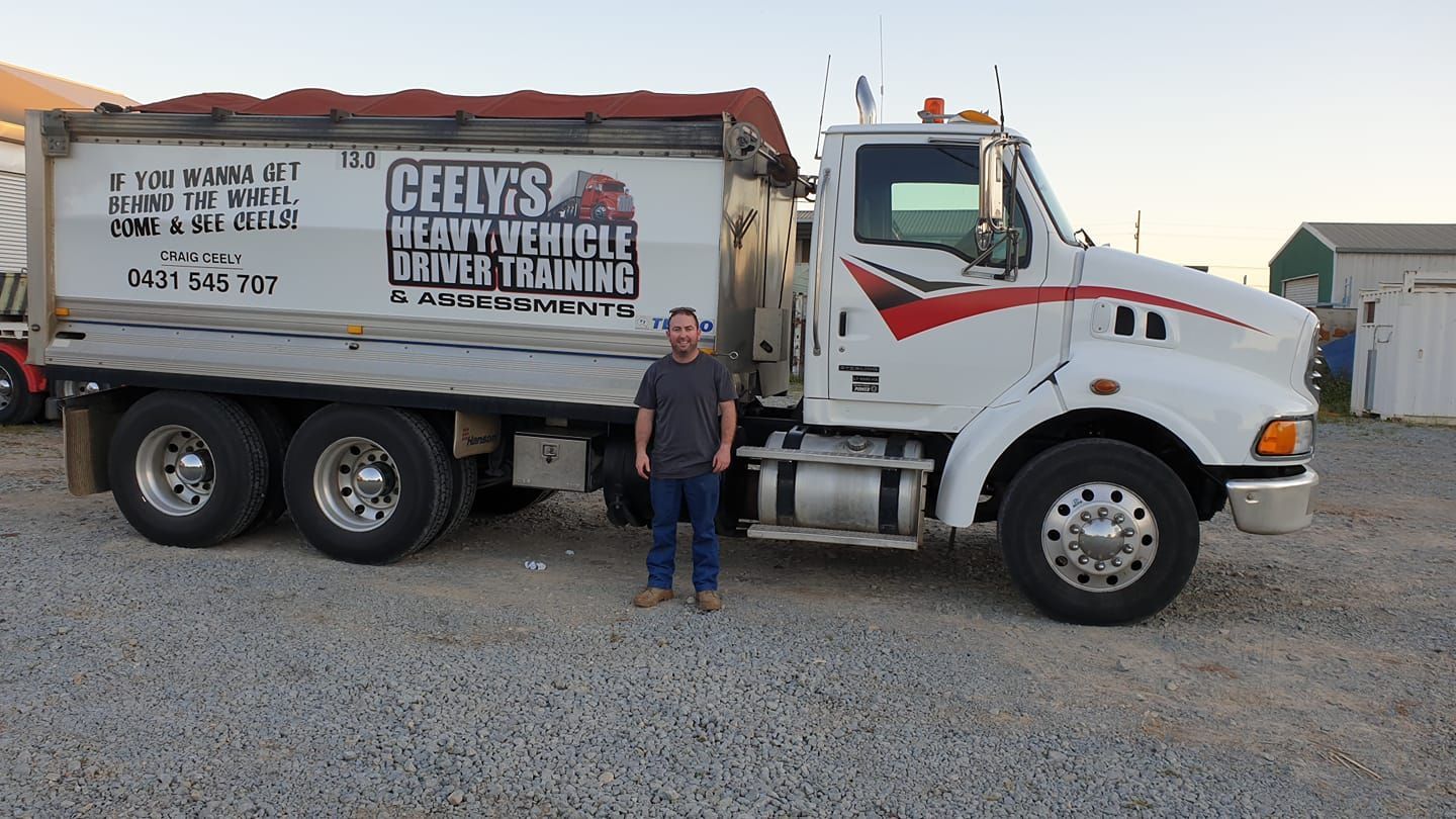 Happy Driver Standing Beside His Truck — Ceely's Heavy Vehicle Driver Training & Assessments In Wagga Wagga, NSW 