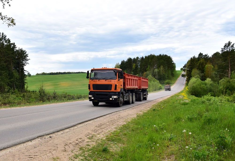 An Orange Dump Truck — Ceely's Heavy Vehicle Driver Training & Assessments In Wagga Wagga, NSW 