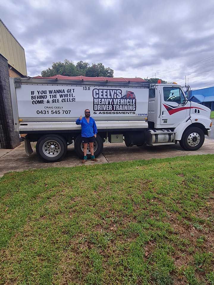 Man With Truck Behind Him — Ceely's Heavy Vehicle Driver Training & Assessments In Wagga Wagga, NSW 