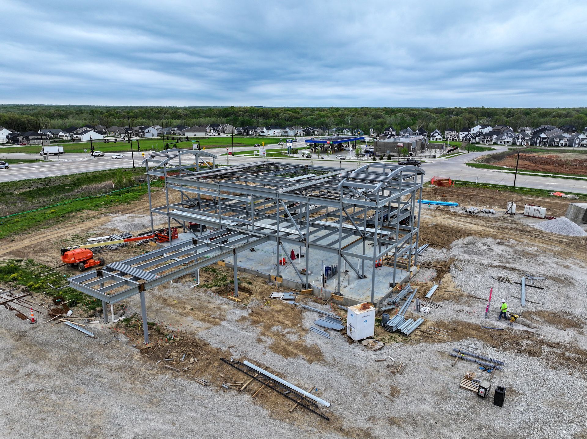 An aerial view of a building under construction in a residential area.