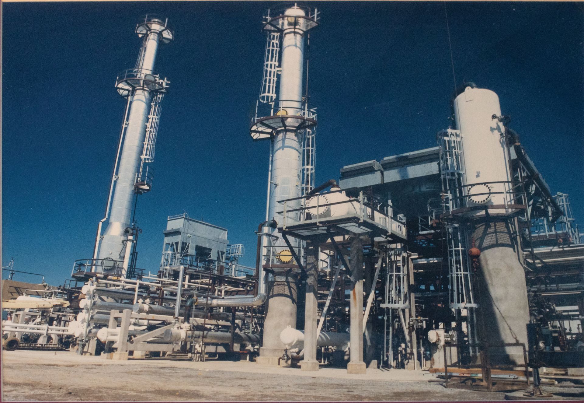 A large industrial plant with a blue sky in the background