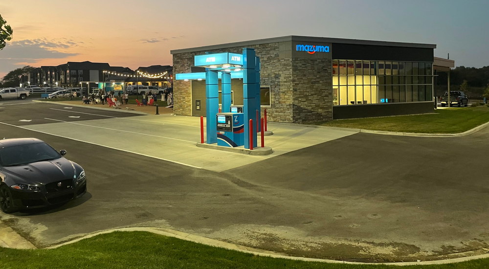 A car is parked in front of a gas station.