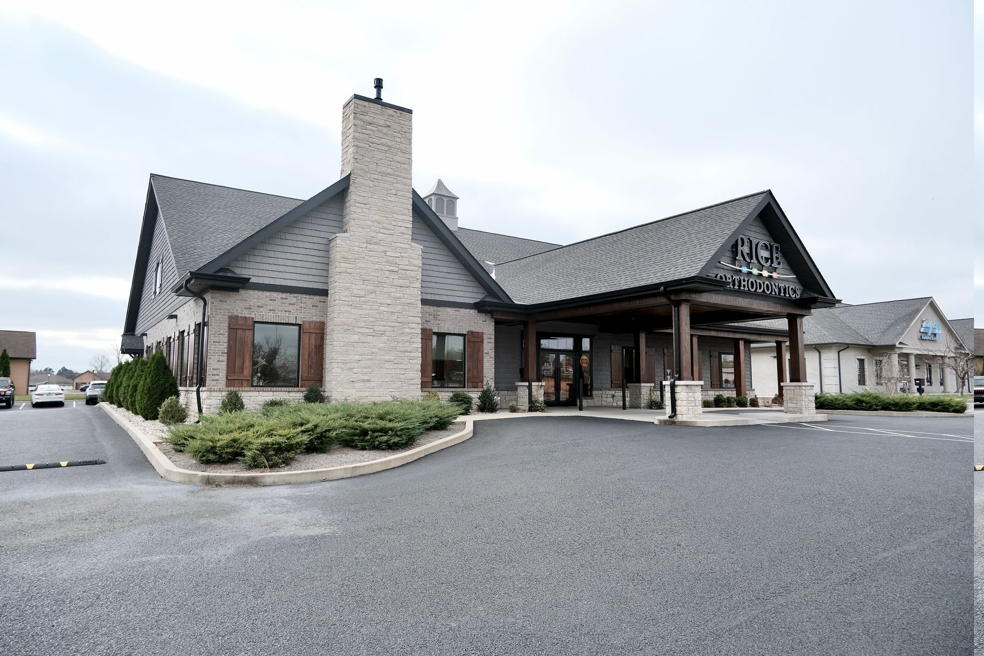 A large building with a parking lot in front of it