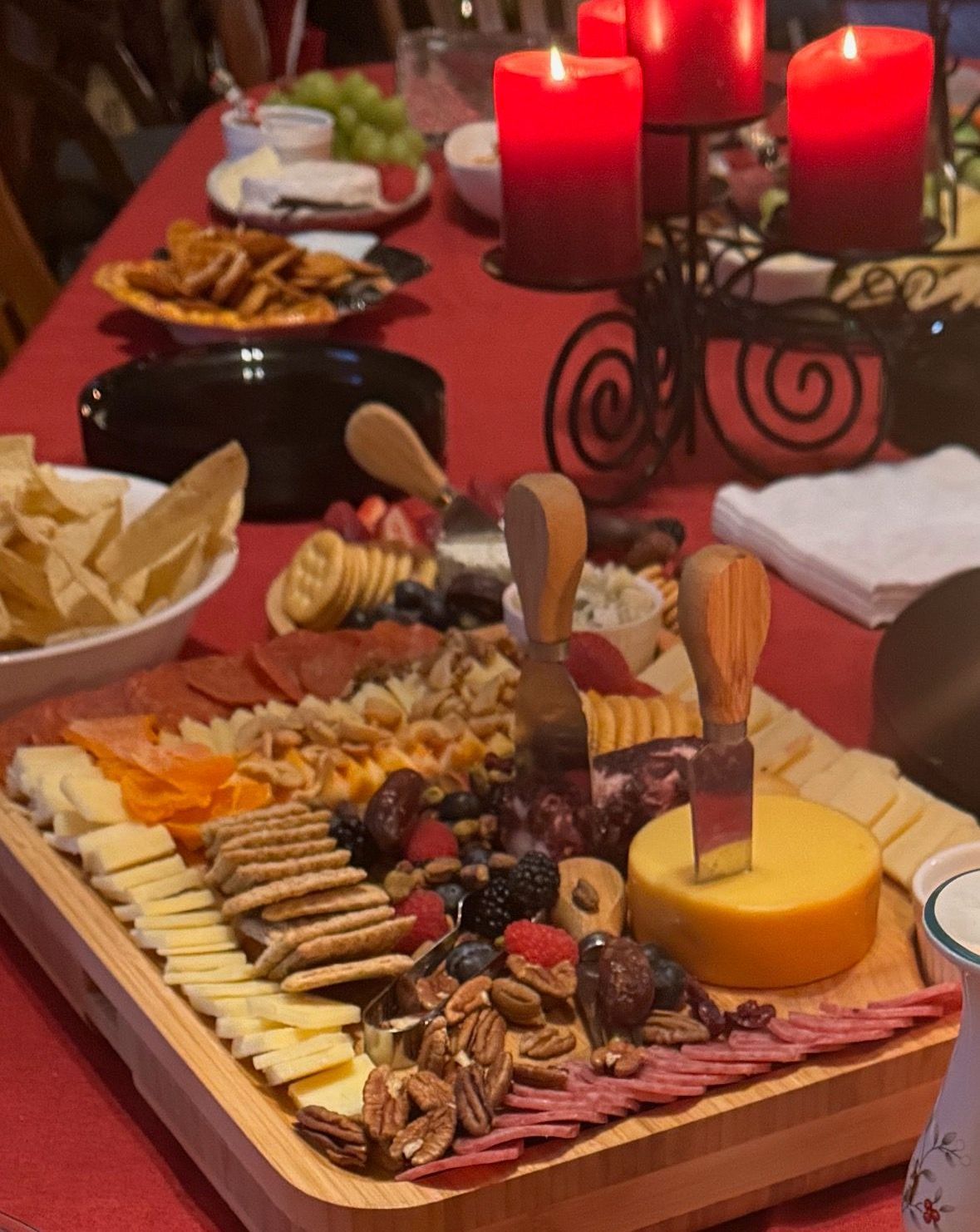 A table with a tray of food and candles on it
