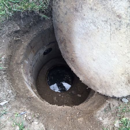 A hole in the ground with water coming out of it.