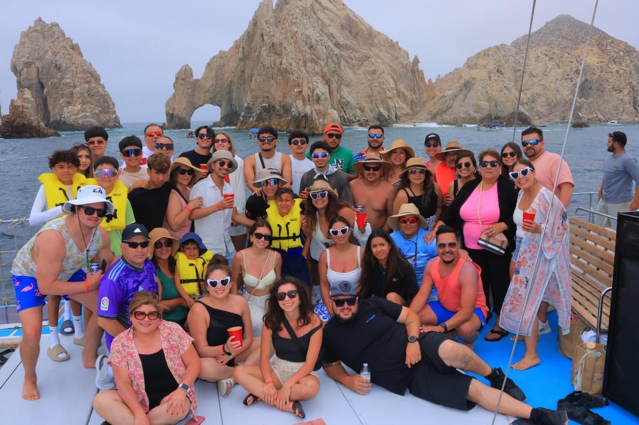 A large group of people are posing for a picture on a boat.