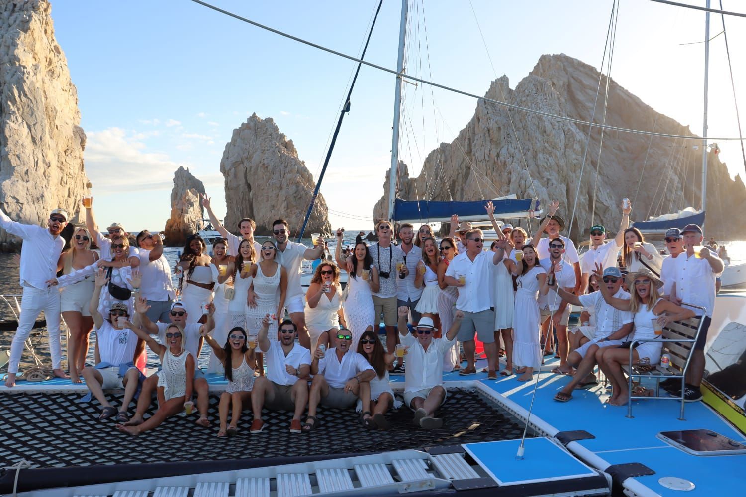 A large group of people are posing for a picture on a boat.