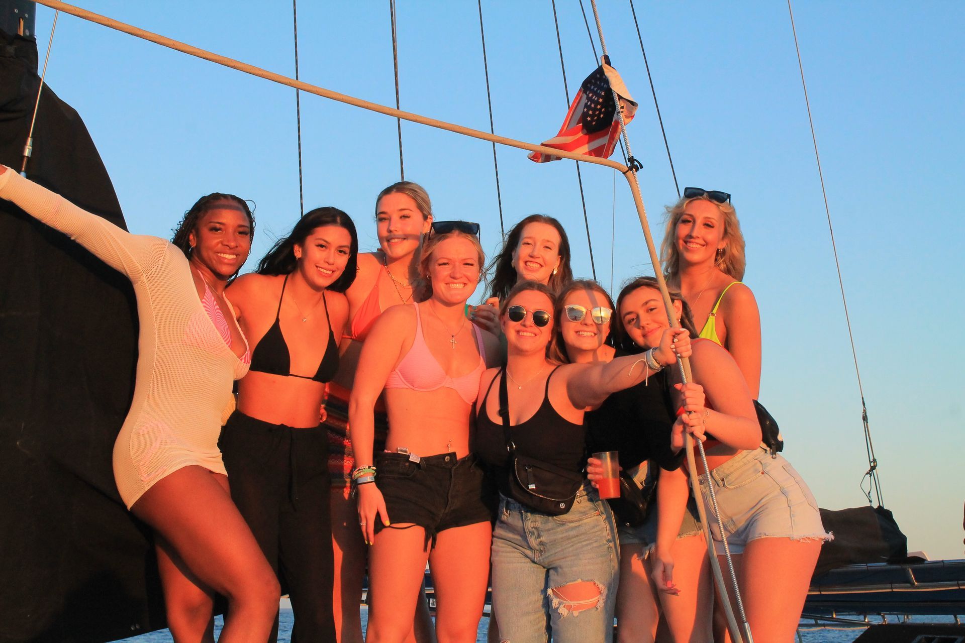 A group of young women are posing for a picture on a boat.