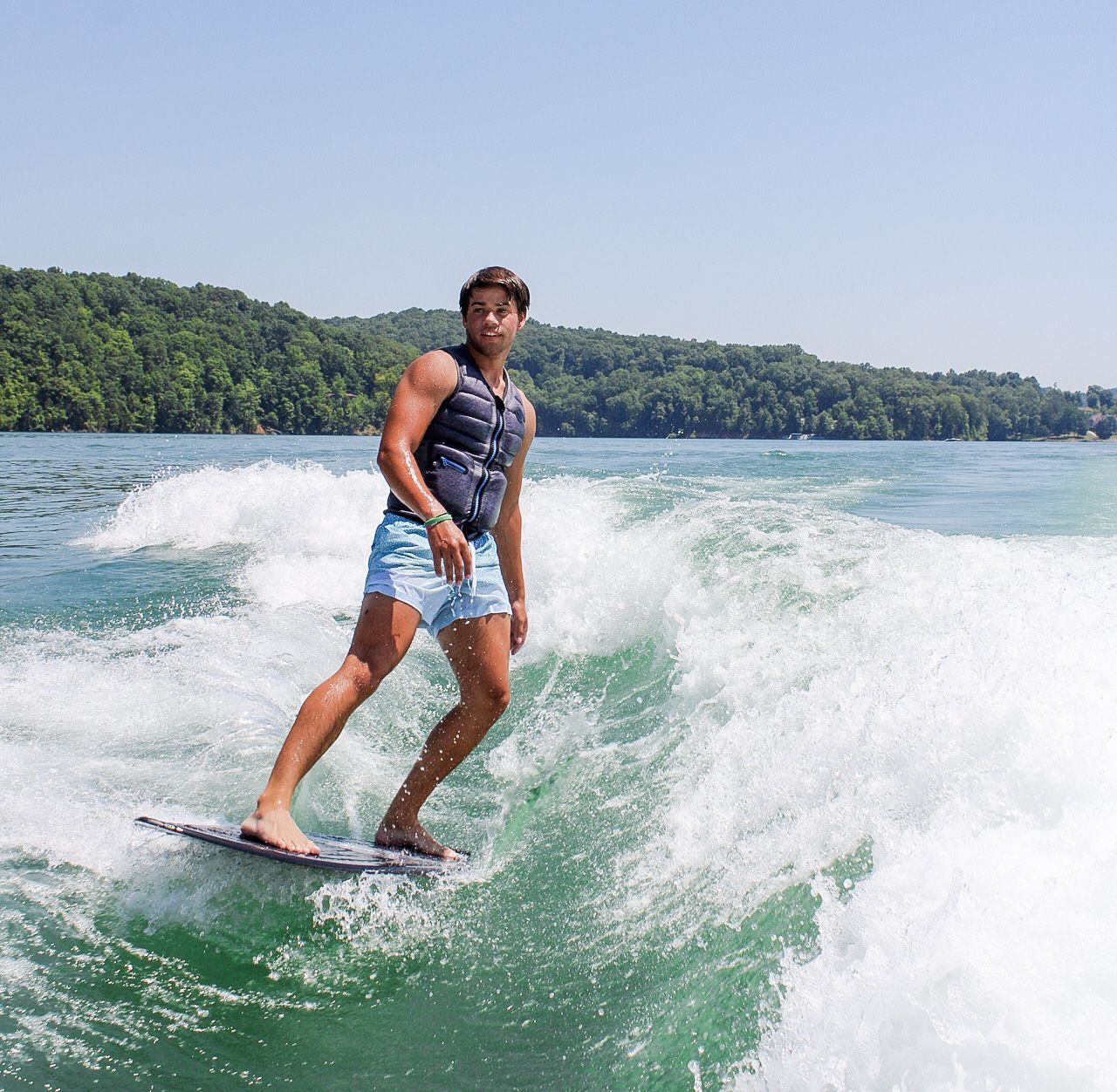 A man is riding a wave on a surfboard