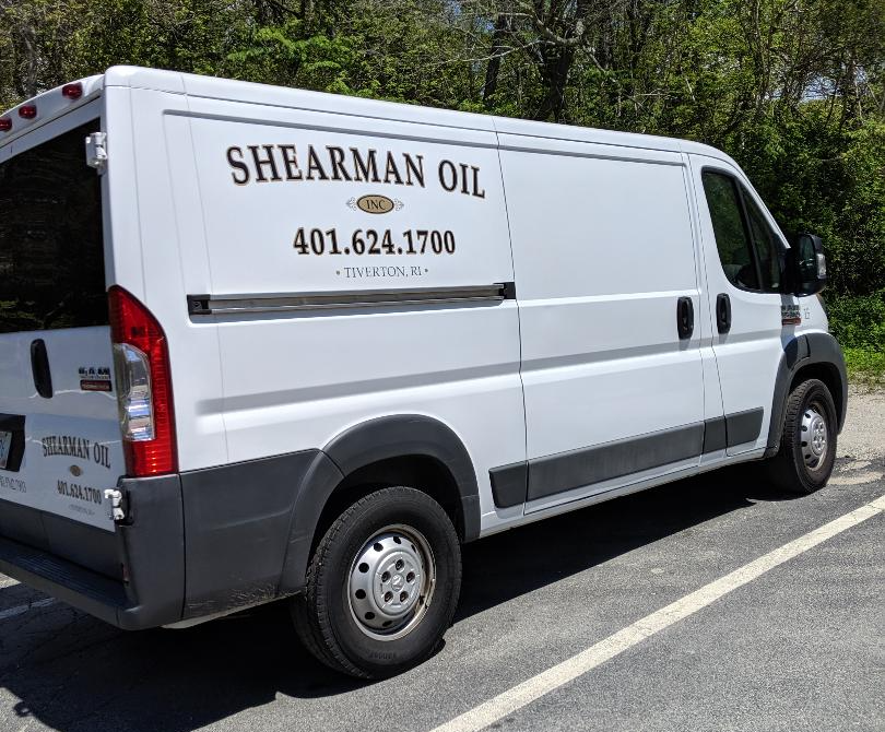 A white van is parked on the side of the road.