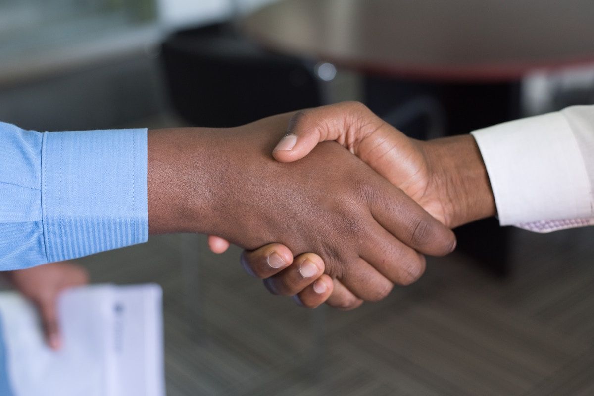 Two business people shaking hands.