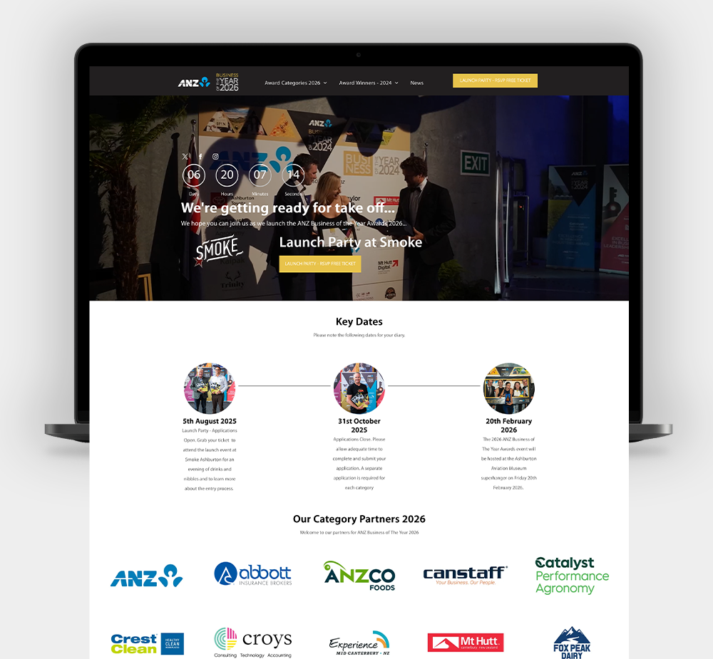 A laptop screen displays an awards website homepage featuring a event photo, timeline, and list of 2024 category partners.