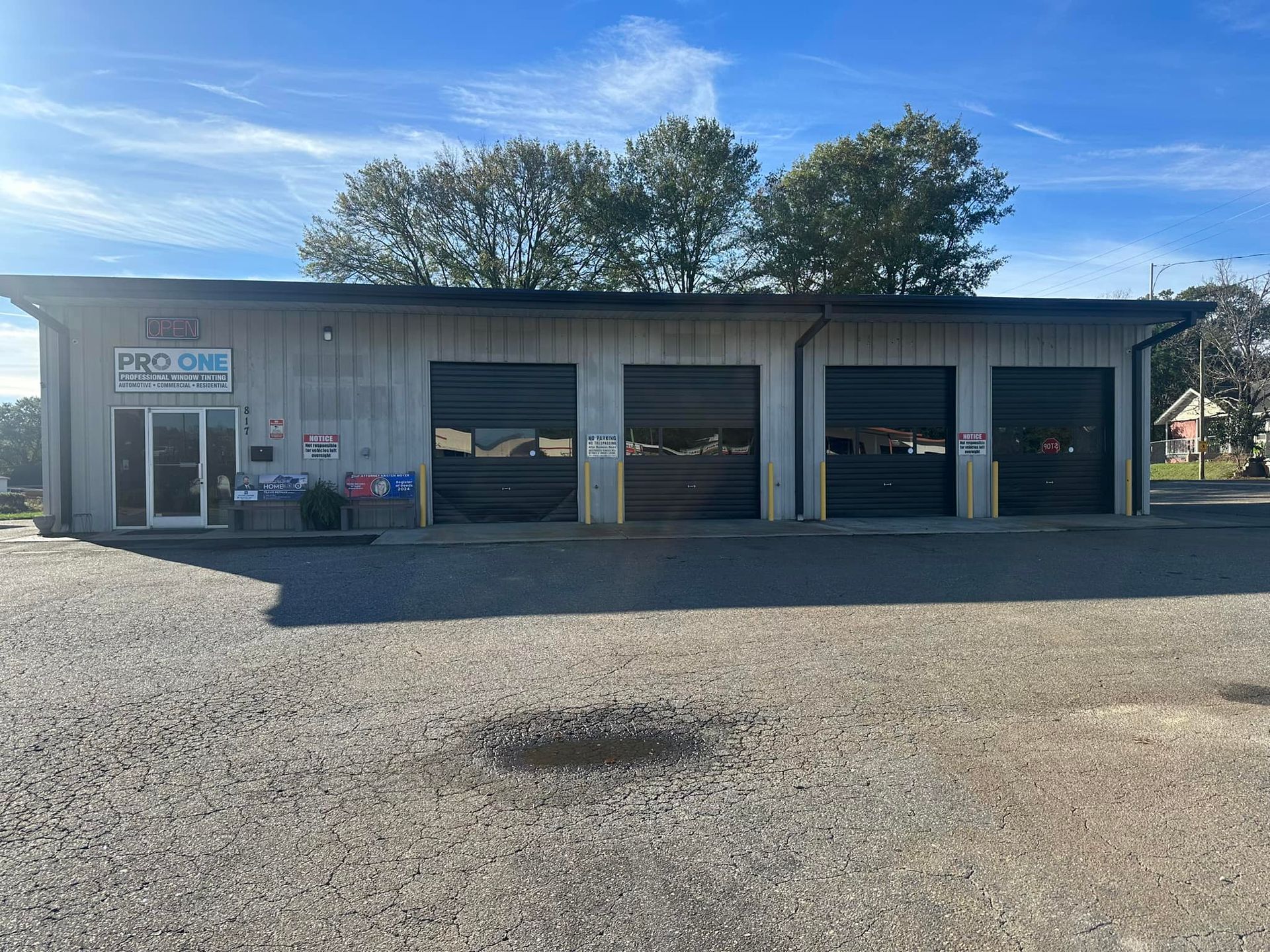Gray building with garage doors; blue sky in background.