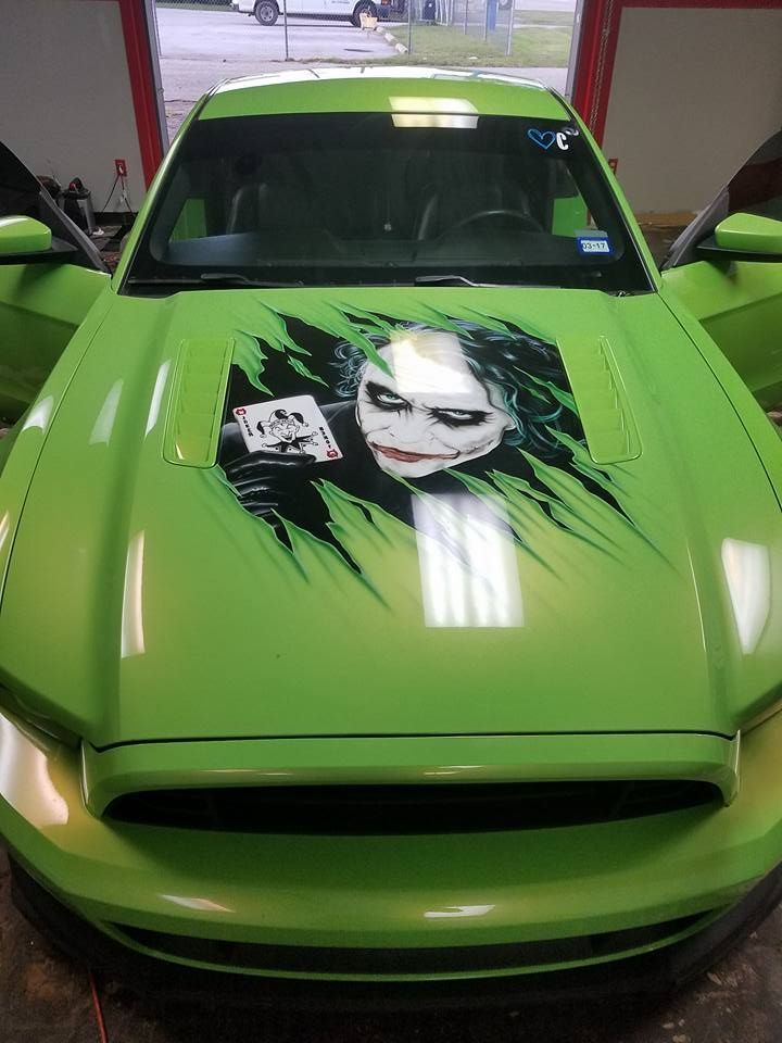 Green Mustang car hood with Joker graphic.