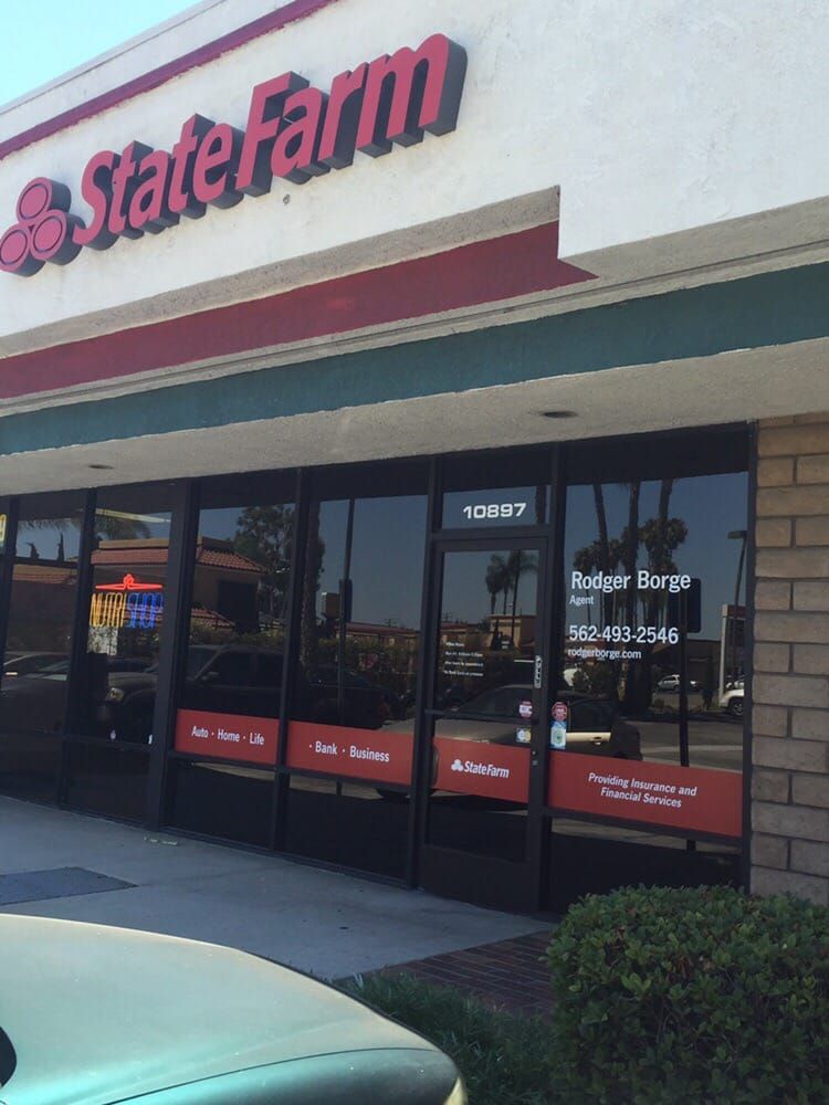 State Farm storefront with black-framed windows and red and white signage.