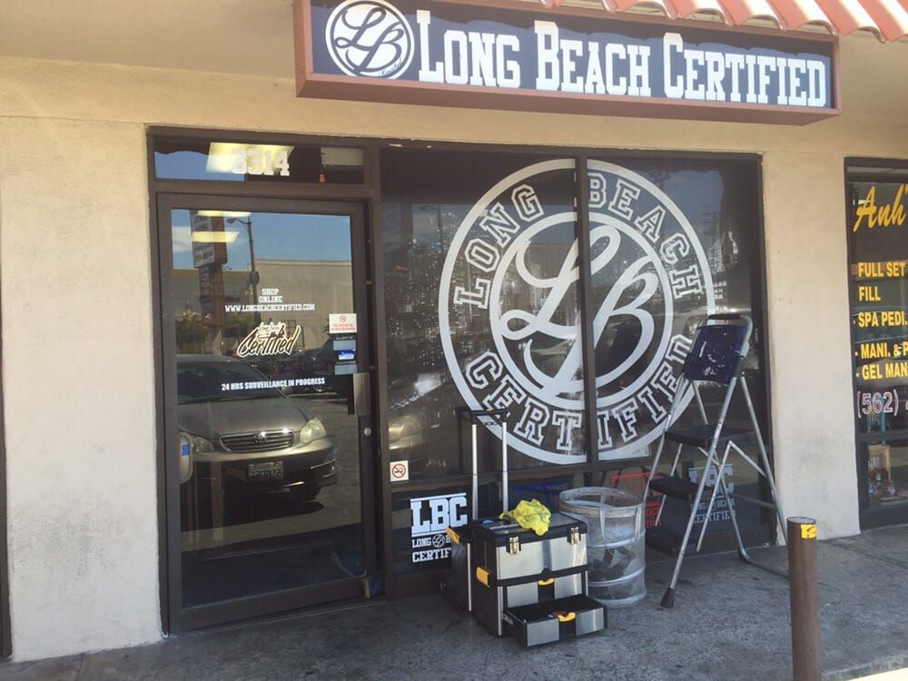 Long Beach Certified storefront with sign and logo on window, tools and equipment on the sidewalk.