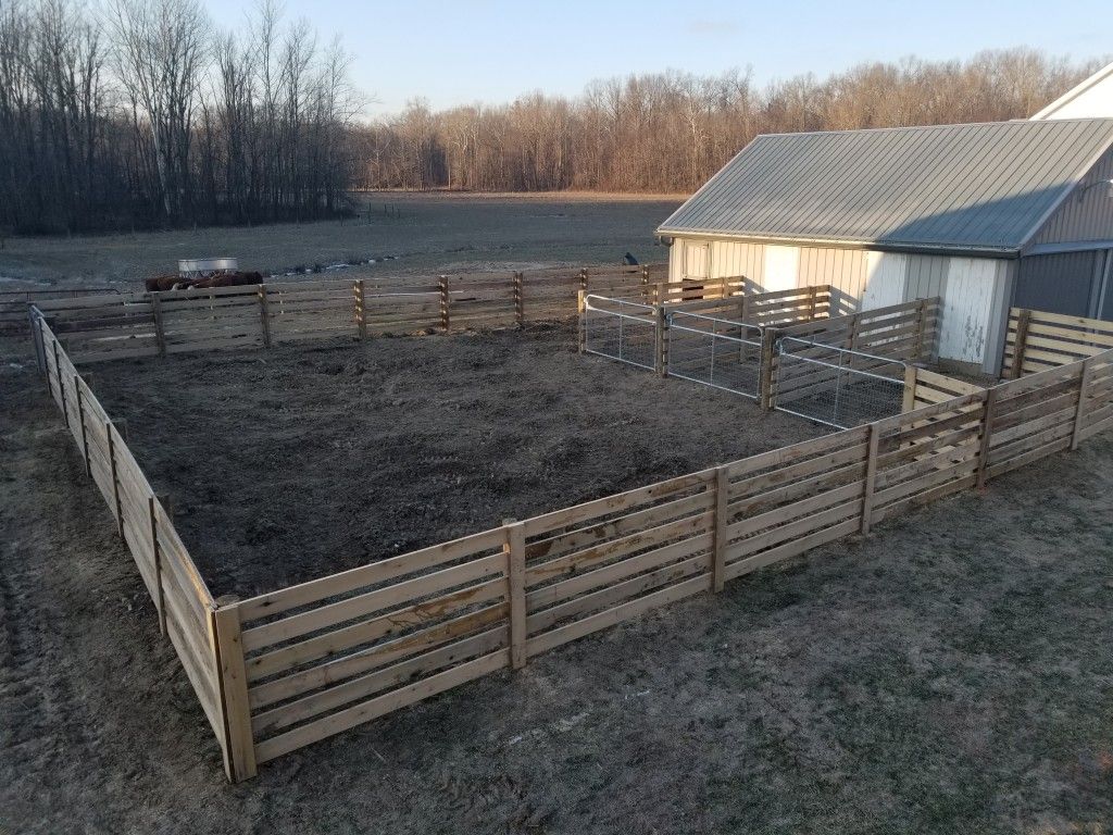 Rustic Barn With A Tall Wooden Fence In The Foreground - Columbus, IN - Indiana Agricultural Fencing