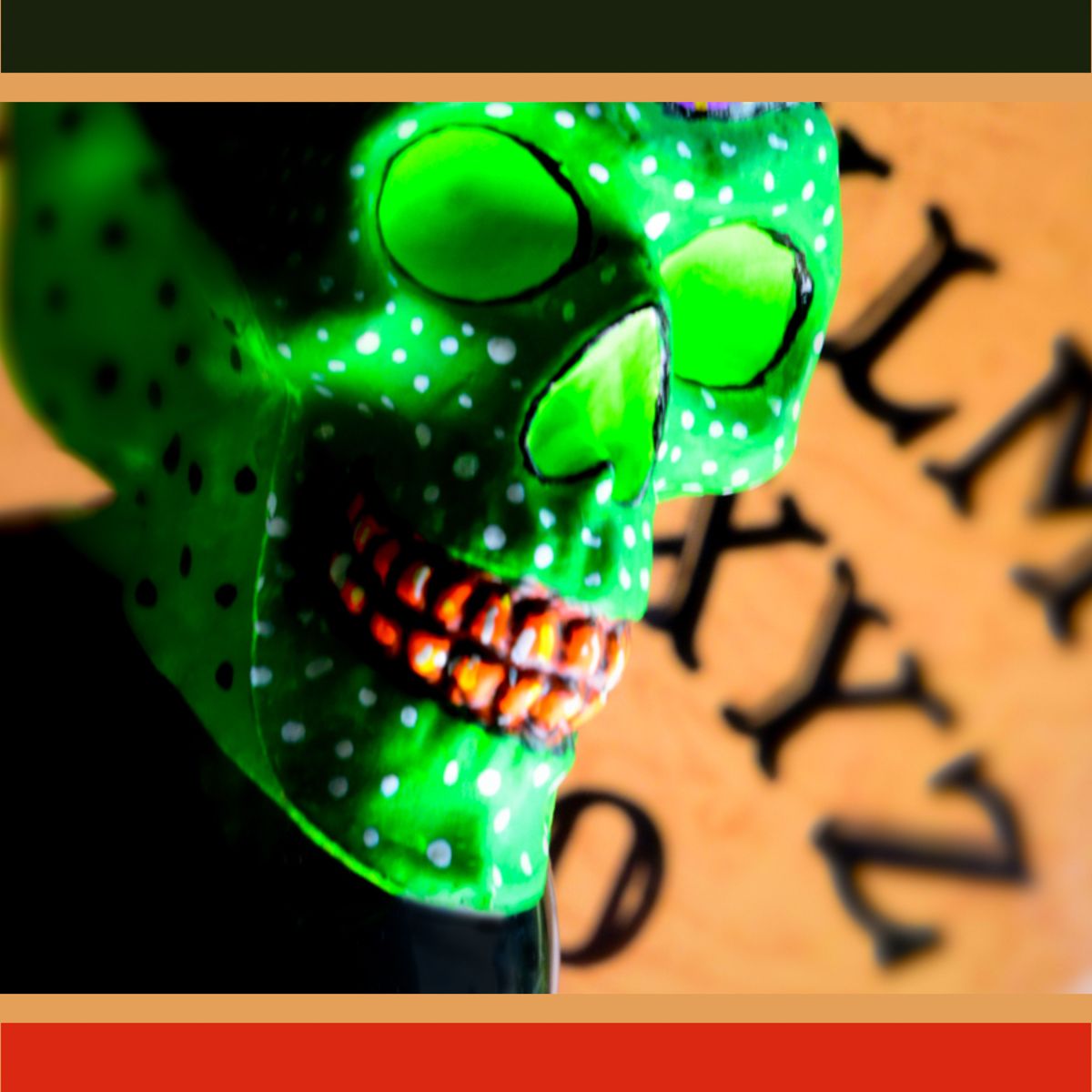 A green skull stands in front of an ouija board