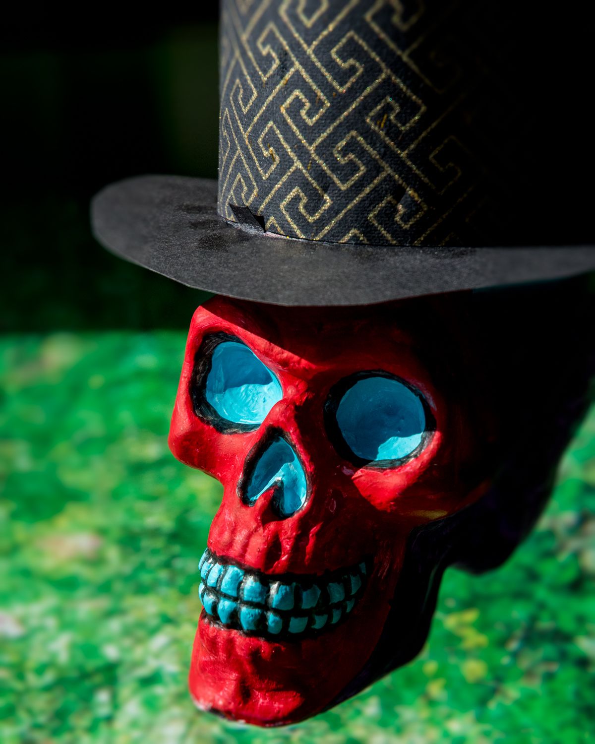 A red skull wearing a black top hat