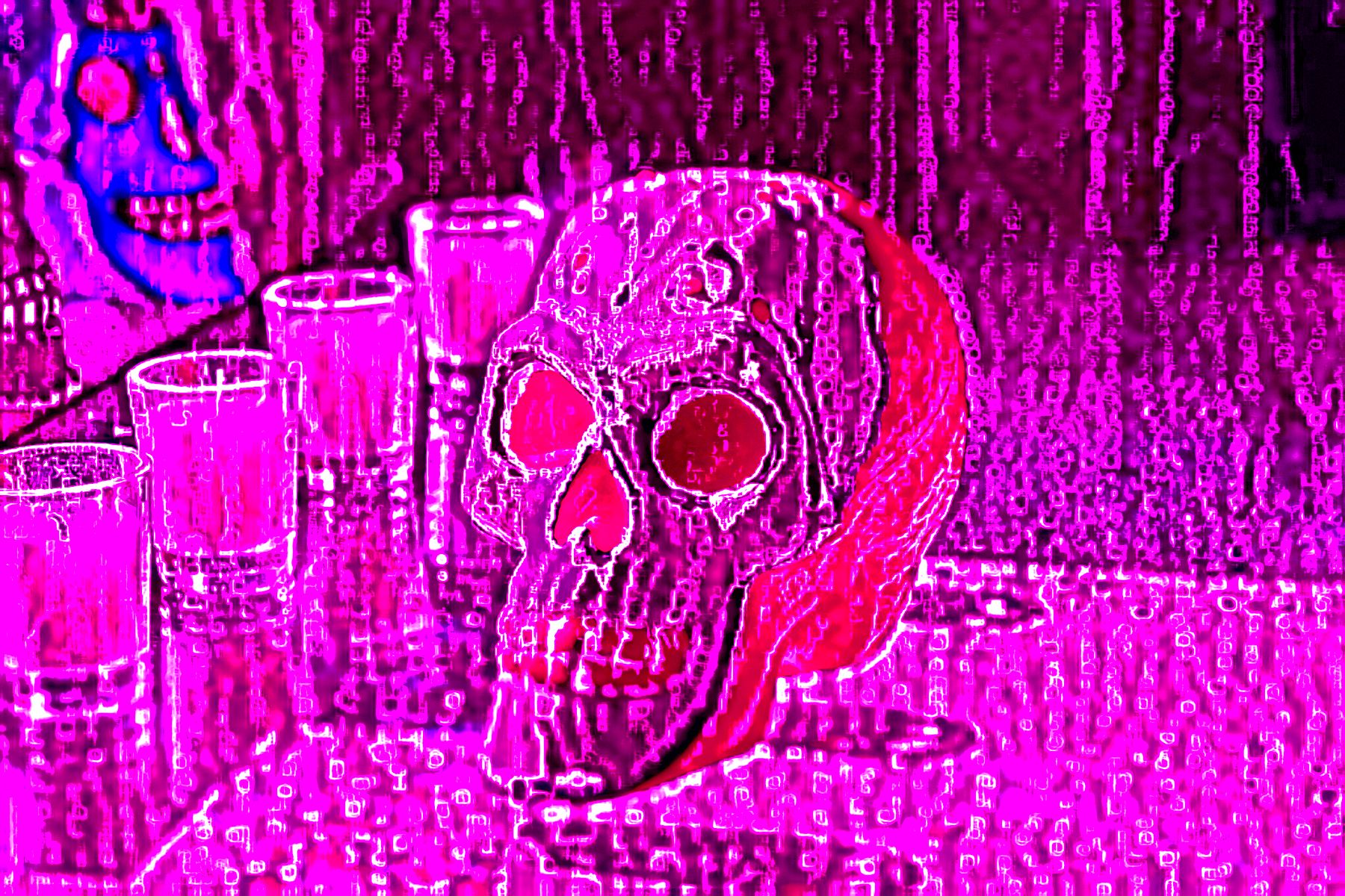 A skull with red eyes is sitting on a table next to glasses.