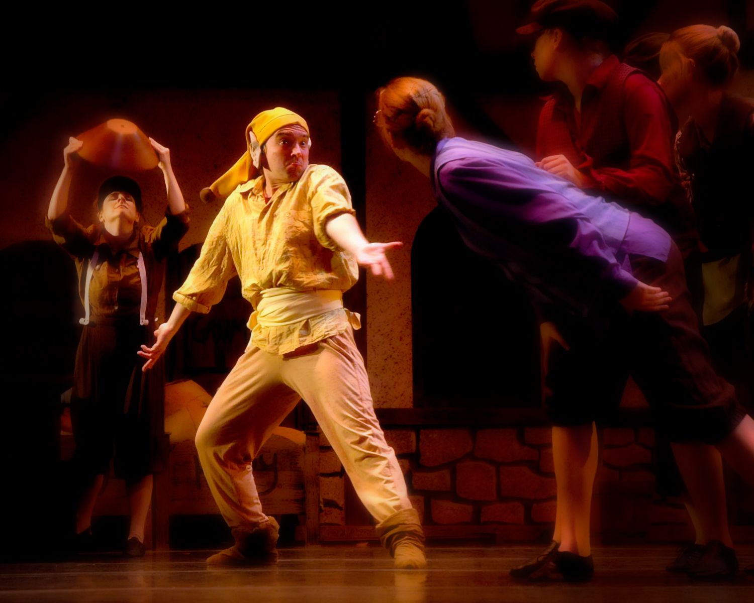 A group of people are playing basketball on a stage