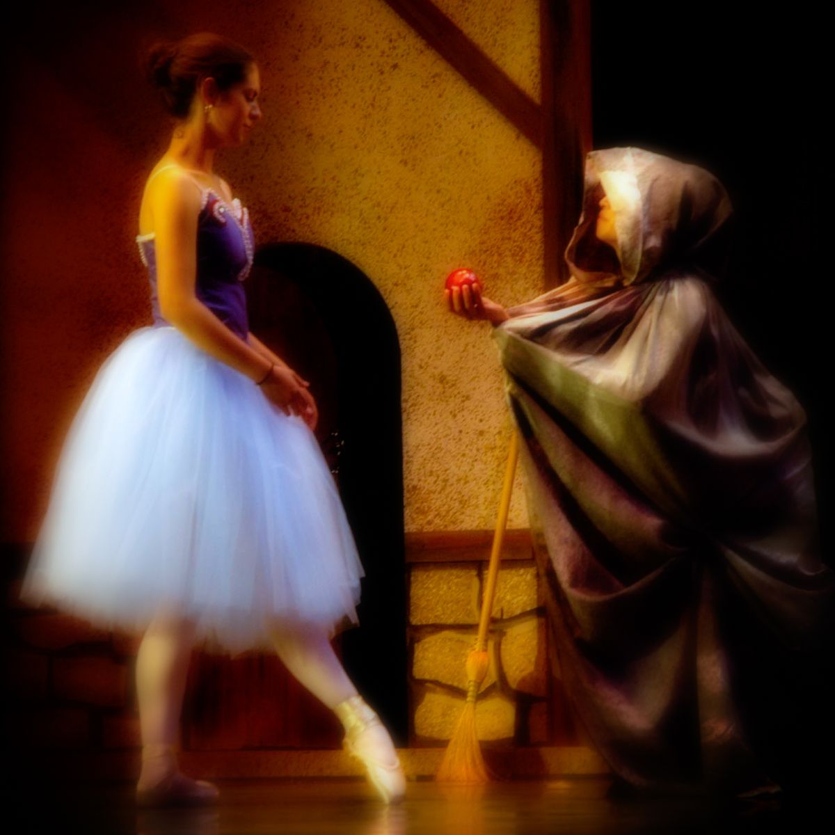 A woman in a blue dress is standing next to a woman in a white dress