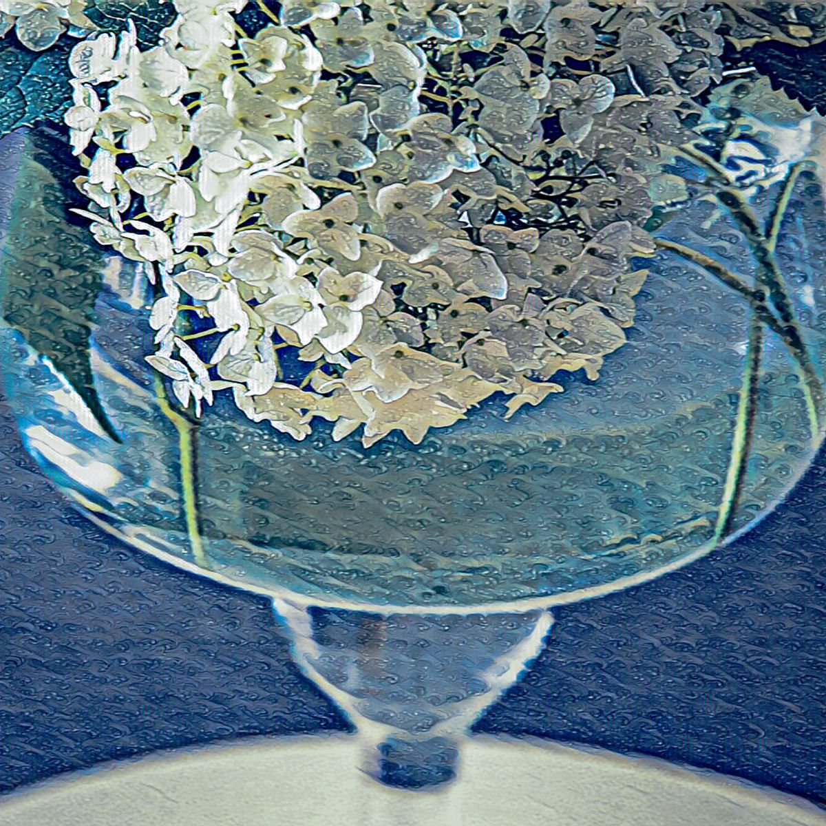 A glass vase filled with white flowers on a table