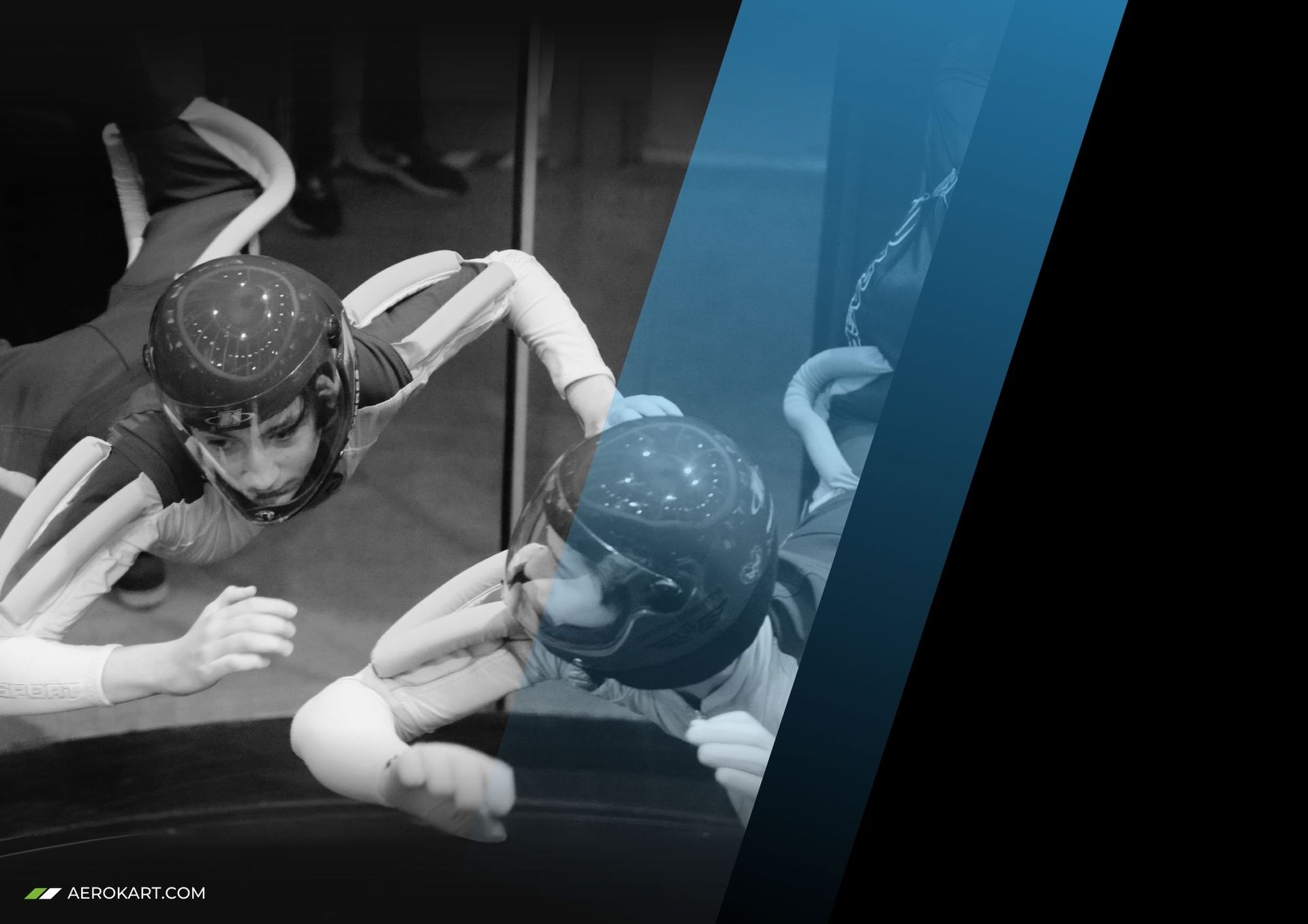 Two people in helmets and flight suits floating in a vertical wind tunnel.
