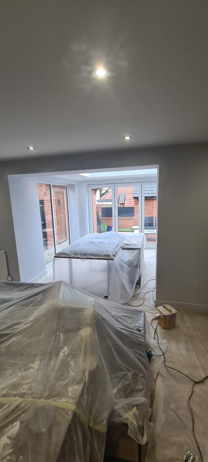 A picture of an open plan kitchen being painted by painters and decorators southampton