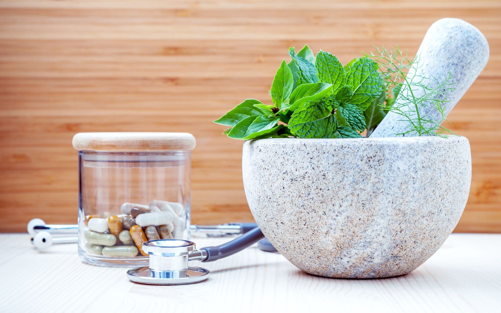 Mortar and pestle with herbs - natural medicine and botanical therapy