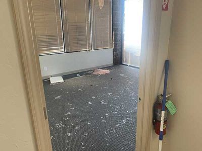 A room with a mop and a fire extinguisher in it.
