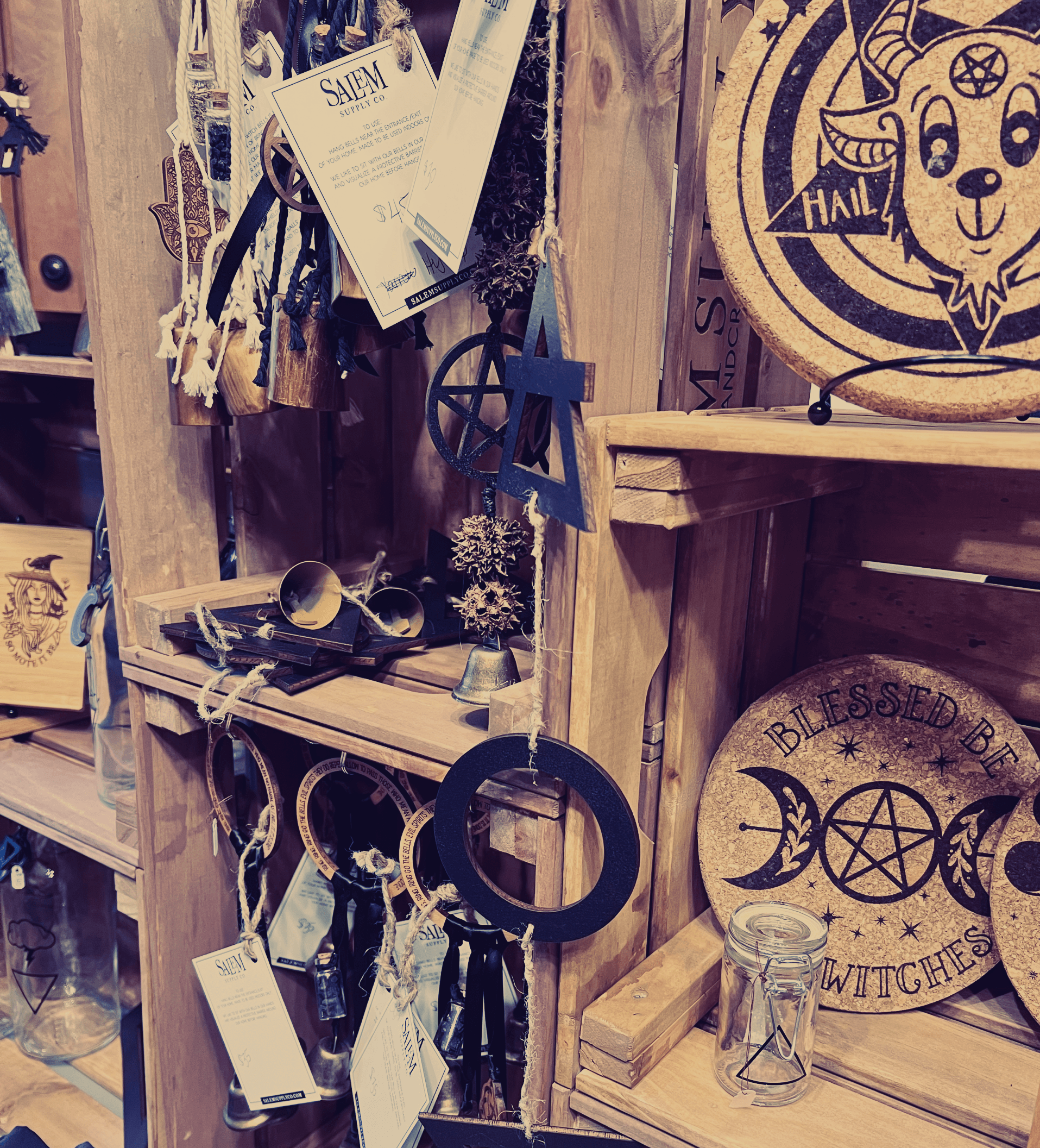 A wooden shelf filled with various items including a plate with a pentagram on it