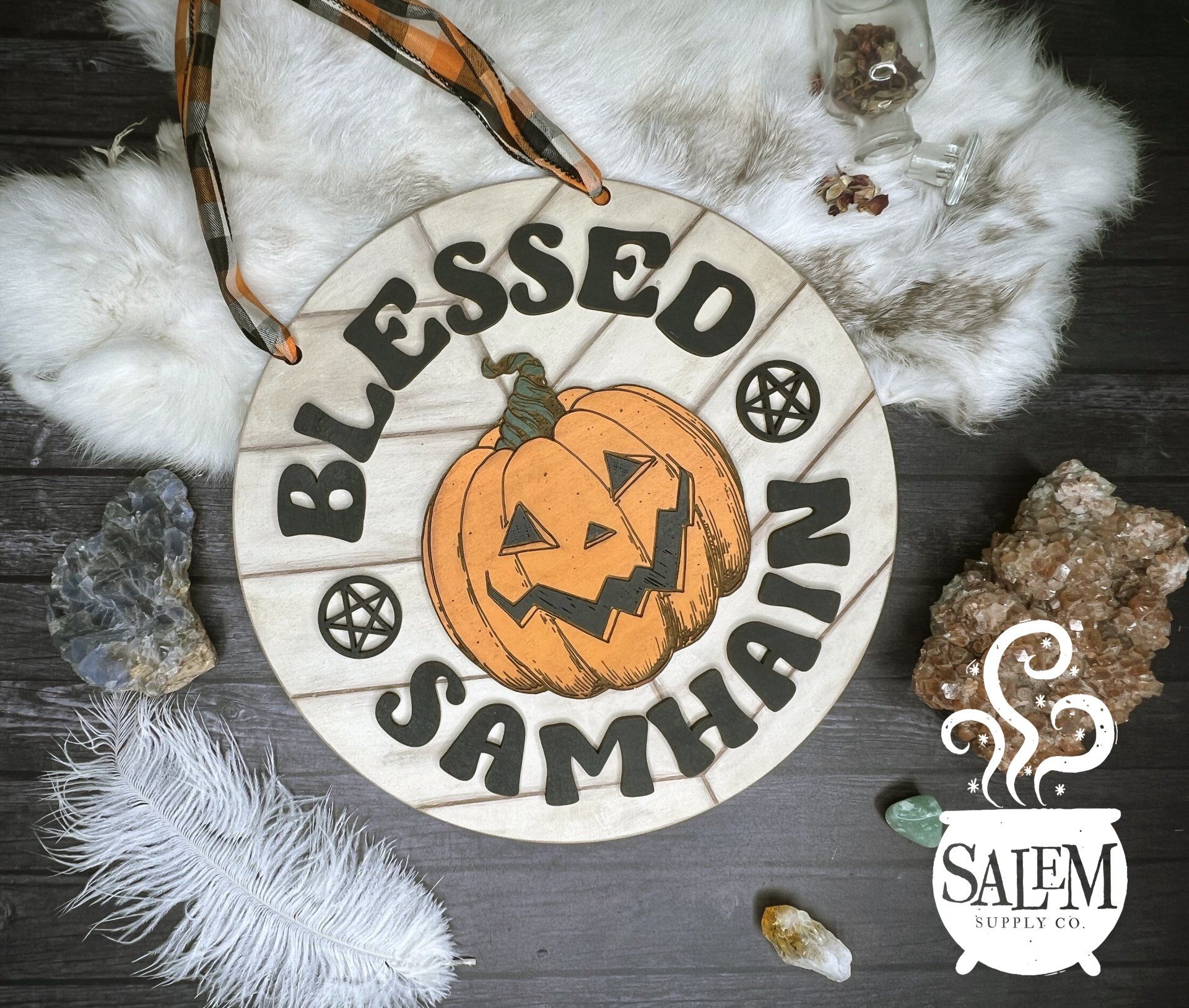 A wooden sign with a pumpkin on it that says blessed samhain