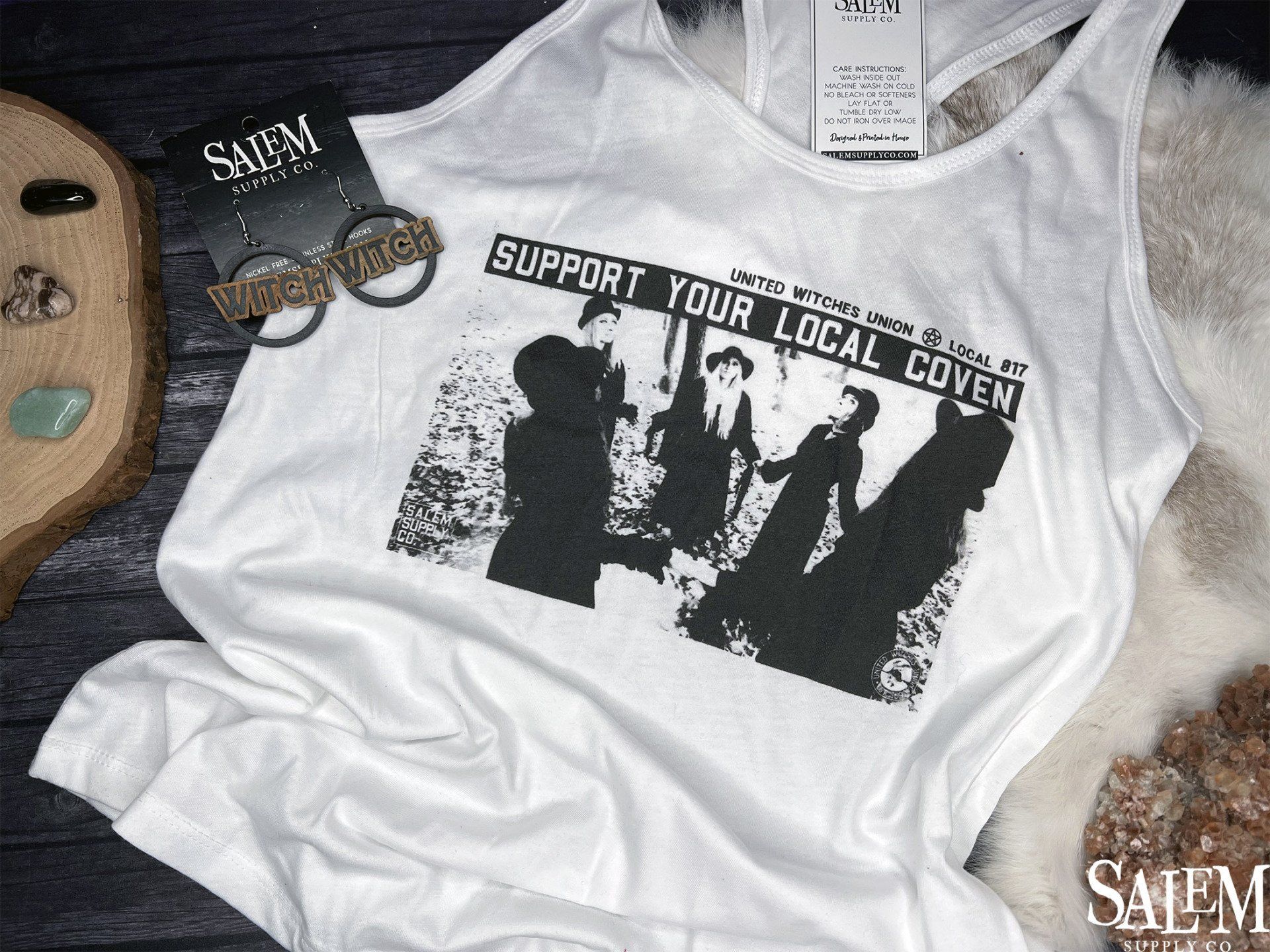A white tank top that says support your local coven
