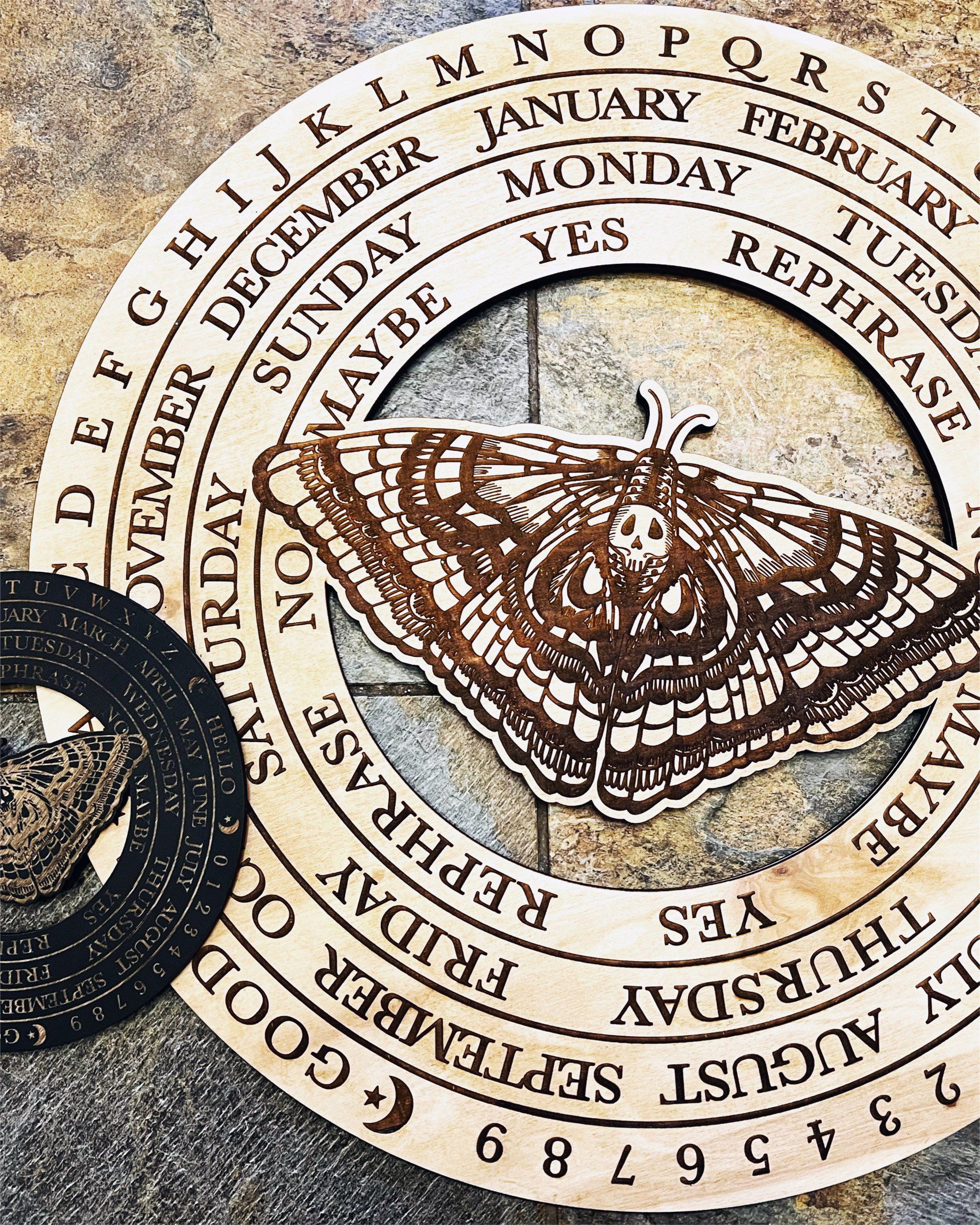 A butterfly is in the middle of a circle with the letters of the alphabet around it.