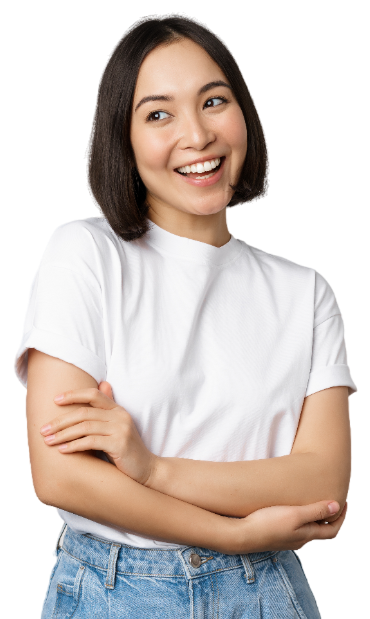 A woman in a white shirt and blue jeans is smiling with her arms crossed.